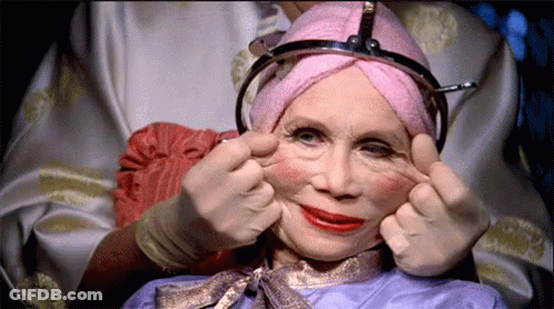 Woman With Pink Towel On Head Making Face GIF