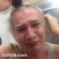 Woman With Ponytail Crying Holding Hair GIF
