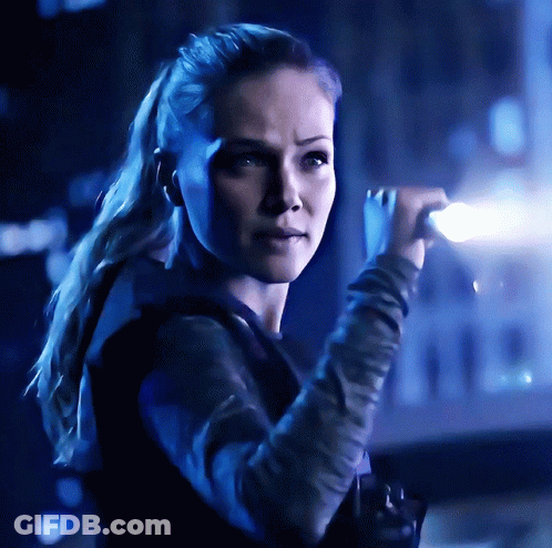 Woman With Ponytail In Dark Room With Blue Light GIF