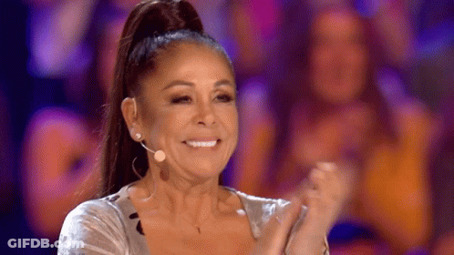 Woman With Ponytail Smiling And Clapping At Microphone GIF