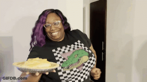 Woman With Purple Hair And Glasses Holding Pie GIF