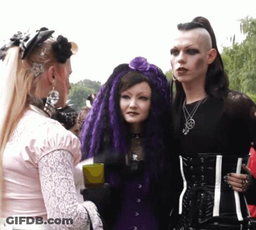 Woman With Purple Hair And Man With Mohawk GIF