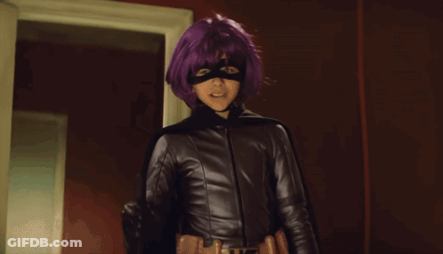 Woman With Purple Hair And Mask In Front Of Looking Sign GIF