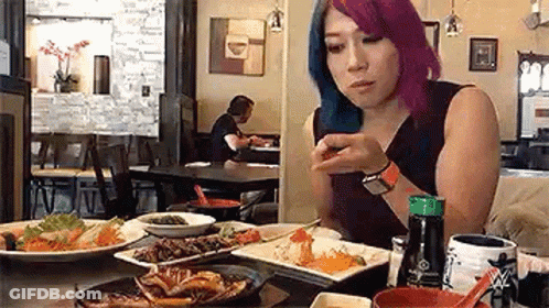 Woman With Purple Hair Eating At Restaurant GIF