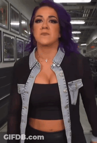 Woman With Purple Hair In Black Crop Top And Denim Jacket GIF