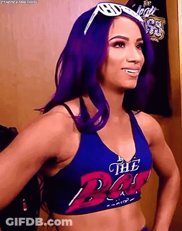 Woman With Purple Hair In Blue Top Saying The Bat GIF