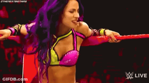 Woman With Purple Hair In Wrestling Ring Holding Rope GIF