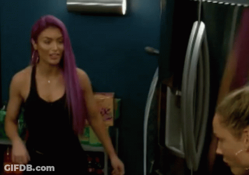 Woman With Purple Hair Talking To Another Woman In Front Of Refrigerator GIF