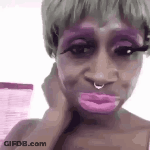 Woman With Purple Makeup Making Funny Face GIF