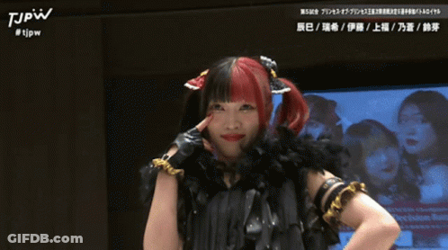 Woman With Red And Black Hair In Black Feather Boa And Gloves GIF
