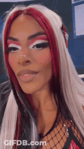 Woman With Red And White Hair And Fishnet Top GIF