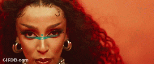 Woman With Red Background And Blue Eye Shadow GIF