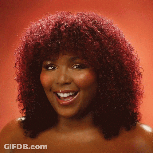 Woman With Red Curly Hair Smiling And Waving GIF