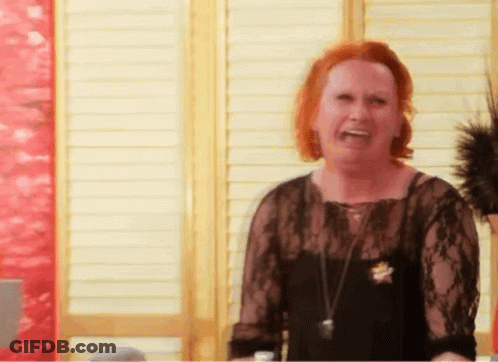 Woman With Red Hair And Black Lace Top Laughing GIF