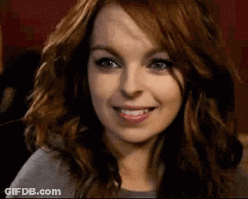 Woman With Red Hair And Blue Eyes Smiling GIF