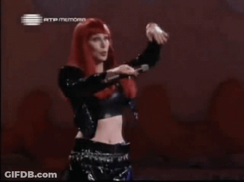 Woman With Red Hair And Crop Top In Front Of Rtp Memoria Sign GIF