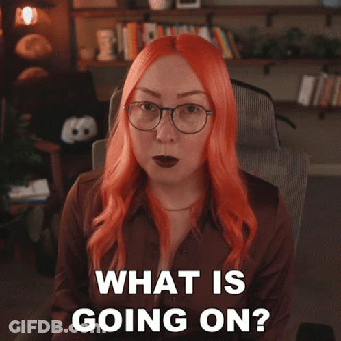 Woman With Red Hair And Glasses Asking What Is Going On GIF
