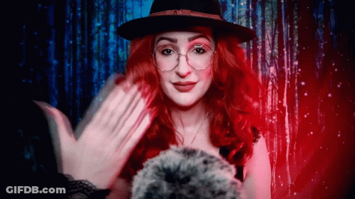 Woman With Red Hair And Glasses Wearing Hat GIF