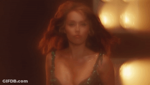 Woman With Red Hair And Plunging Neckline GIF