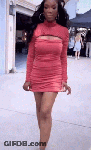 Woman With Red Hair And White Pants In Dark Room GIF