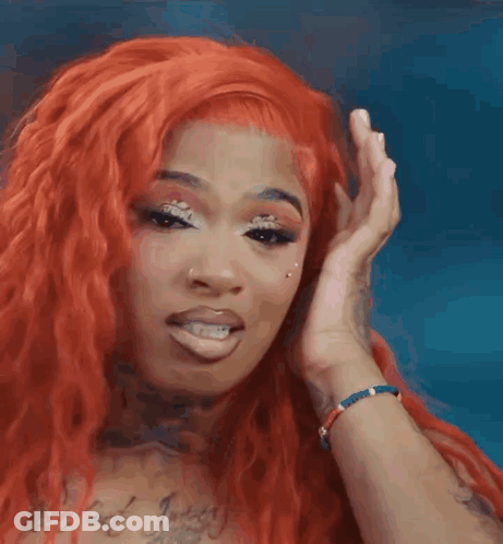 Woman With Red Hair Covering Ear GIF
