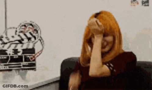 Woman With Red Hair Covering Face GIF