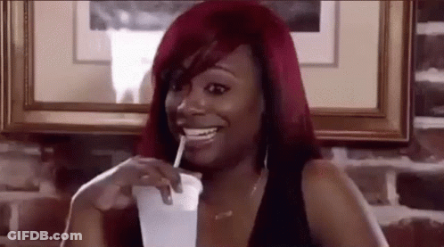Woman With Red Hair Drinking Through Straw GIF