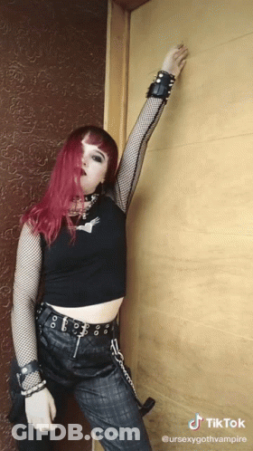 Woman With Red Hair In Black Crop Top And Pants GIF