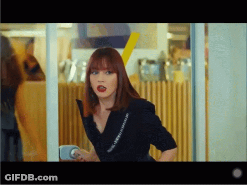 Woman With Red Hair In Black Shirt Saying I Love You GIF