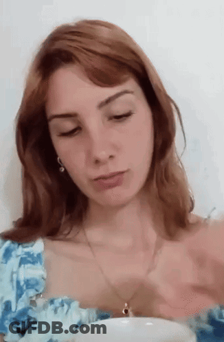 Woman With Red Hair In Blue And White Floral Top GIF