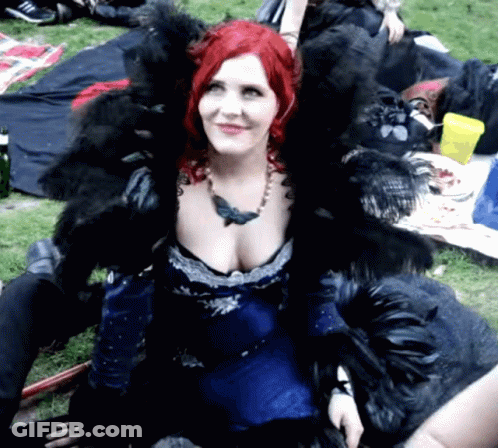 Woman With Red Hair In Blue Dress And Black Fur GIF