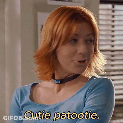 Woman With Red Hair In Blue Shirt Says Cutie Patootie GIF