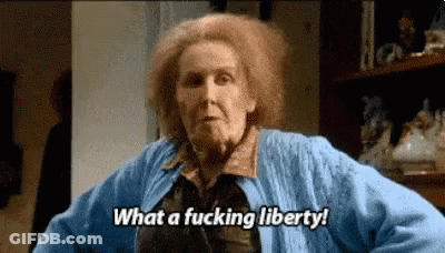 Woman With Red Hair In Blue Sweater Saying What A Fucking Liberty GIF