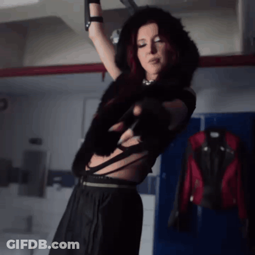 Woman With Red Hair In Dark Room GIF