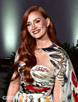 Woman With Red Hair In Floral Dress Smiling GIF