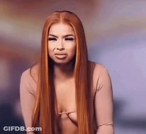 Woman With Red Hair In Revealing Top Making Funny Face GIF