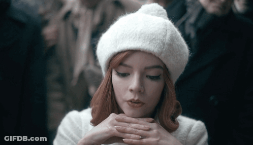 Woman With Red Hair In White Hat And Coat GIF