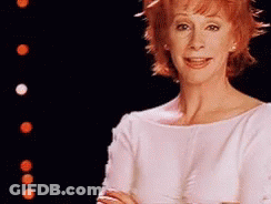 Woman With Red Hair In White Top GIF