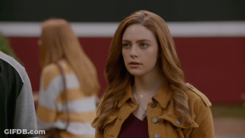 Woman With Red Hair In Yellow Jacket GIF