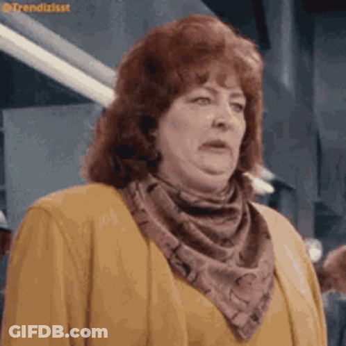 Woman With Red Hair In Yellow Sweater And Scarf GIF