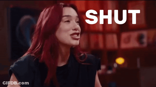 Woman With Red Hair Laughing At Shut Up Sign GIF