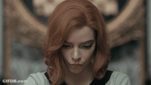 Woman With Red Hair Looking At Camera GIF