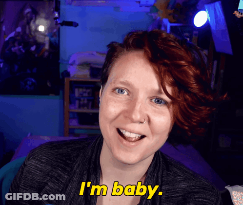 Woman With Red Hair Says I'm Baby In Yellow Letters GIF