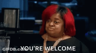 Woman With Red Hair Sitting At Table GIF
