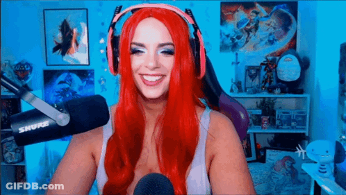 Woman With Red Hair Smiling At Microphone GIF