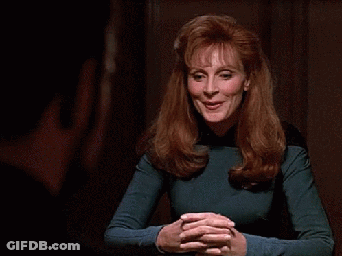 Woman With Red Hair Smiling In Blue Top GIF