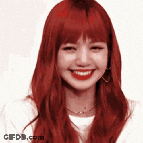Woman With Red Hair Smiling In White Shirt And Earrings GIF