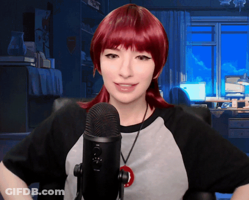 Woman With Red Hair Speaking Into Black Microphone GIF