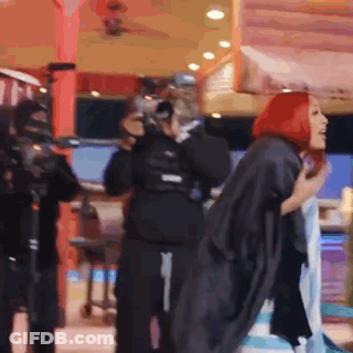 Woman With Red Hair Standing In Front Of Crowd GIF
