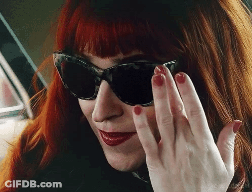 Woman With Red Hair Sunglasses And Nails GIF